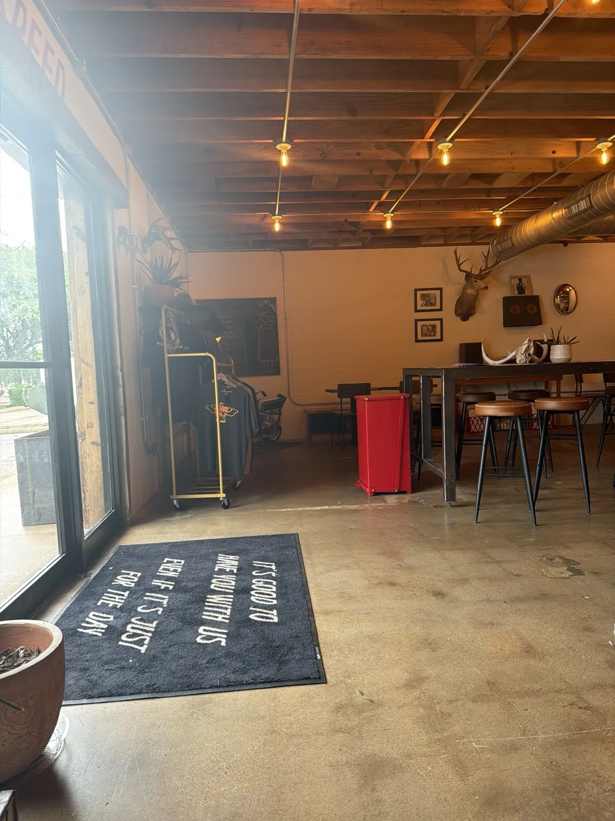 Moon Wolf lounge area with deer mount and welcome mat reading "It's good to see you"