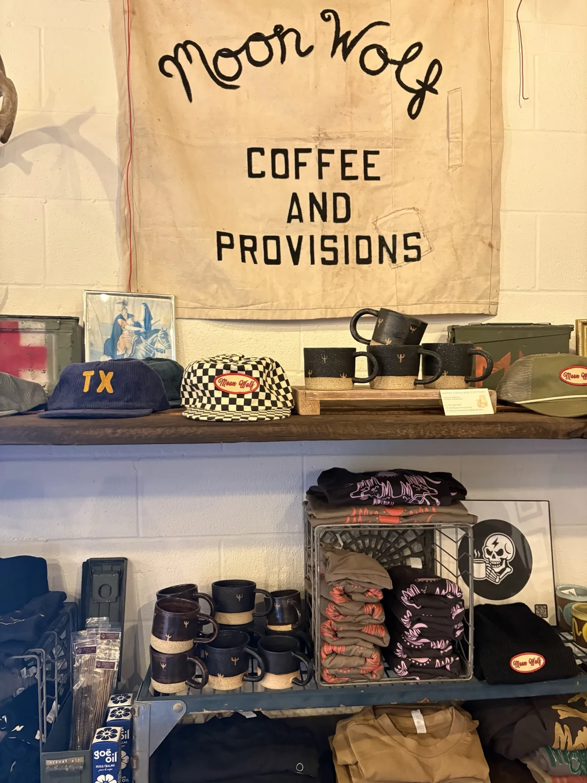 Shelf of Moon Wolf ceramic mugs and provisions merchandise