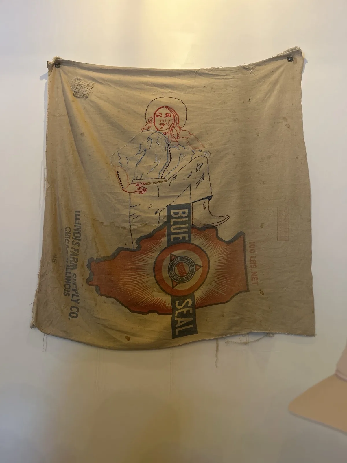 Vintage Blue Seal cowgirl banner hanging at Moon Wolf Provisions