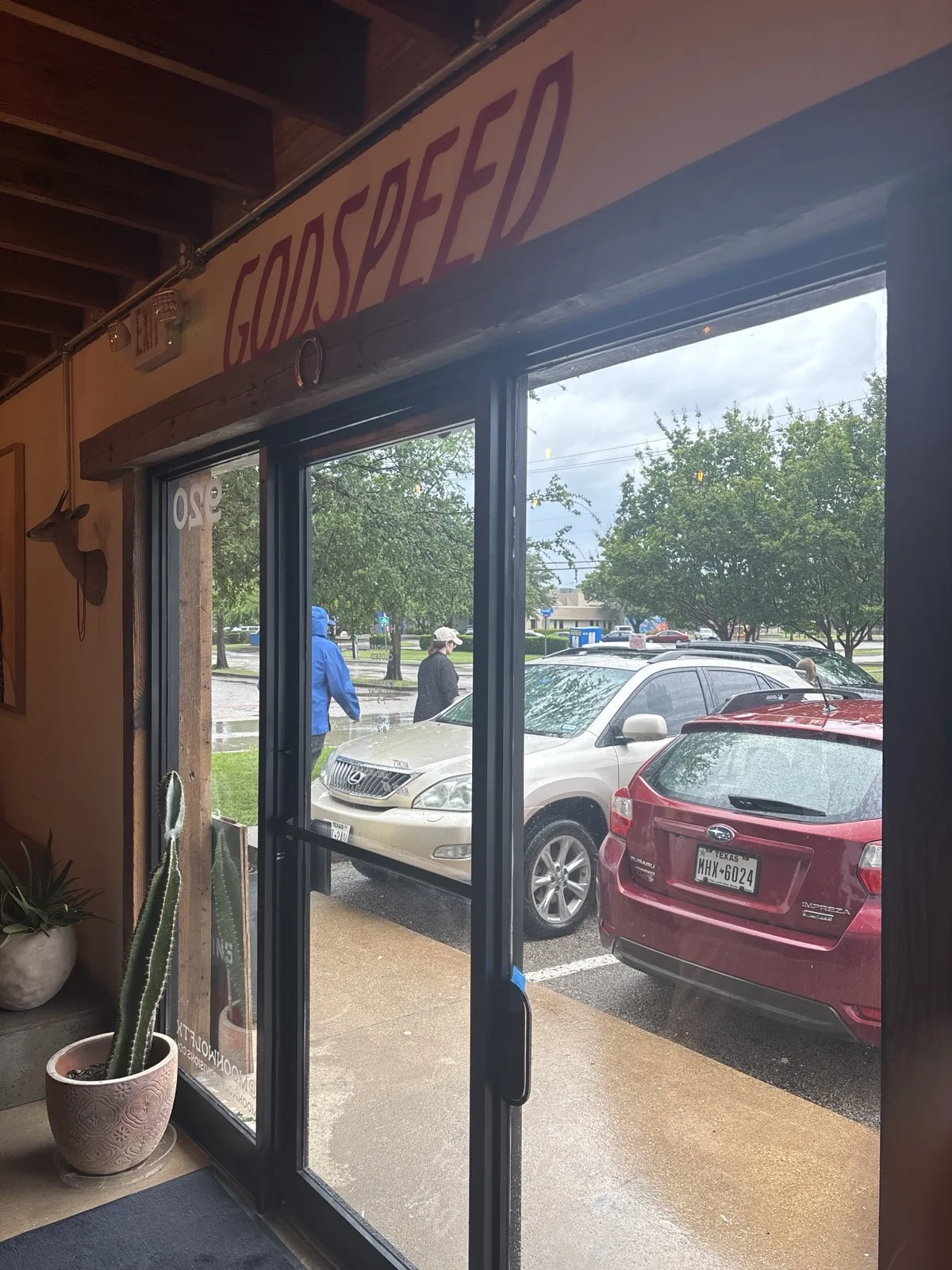 Front entrance at Moon Wolf with "Godspeed" signage over the door